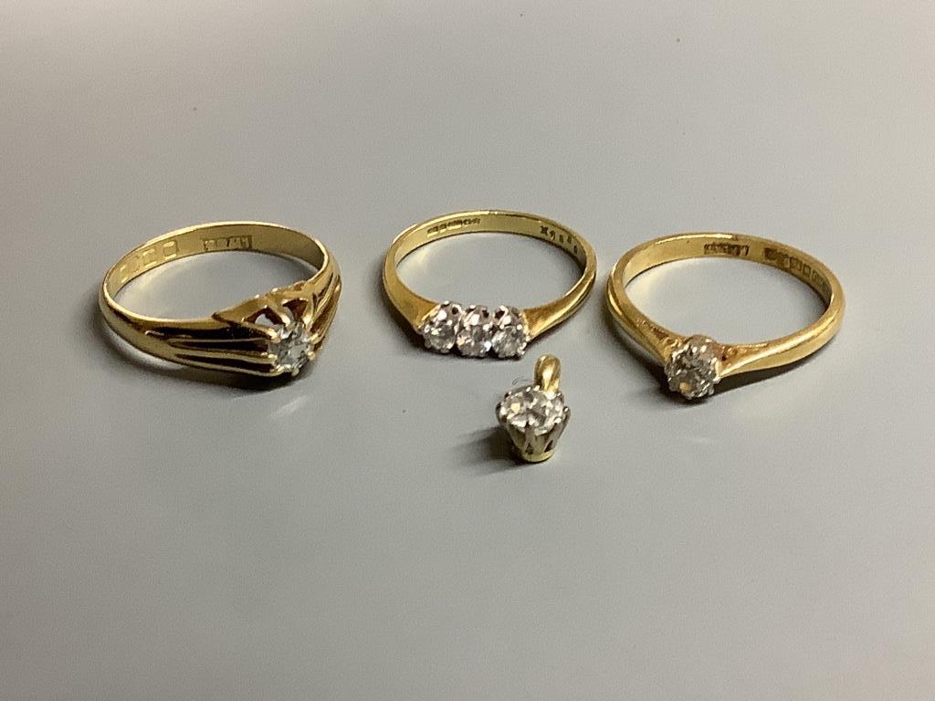 Three assorted 18 carat gold and diamond set dress rings, gross 8.3 g and yellow metal and diamond set small pendant, gross 0.7 g.